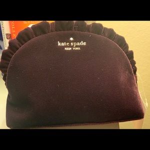 A deep plum Kate Spade clutch  bag.